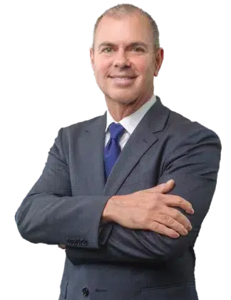 Professional man in a suit, smiling with arms crossed.