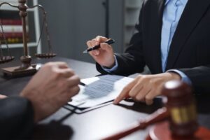 Attorney consulting client over legal documents with scales of justice, highlighting Texas statute of limitations for injury claims